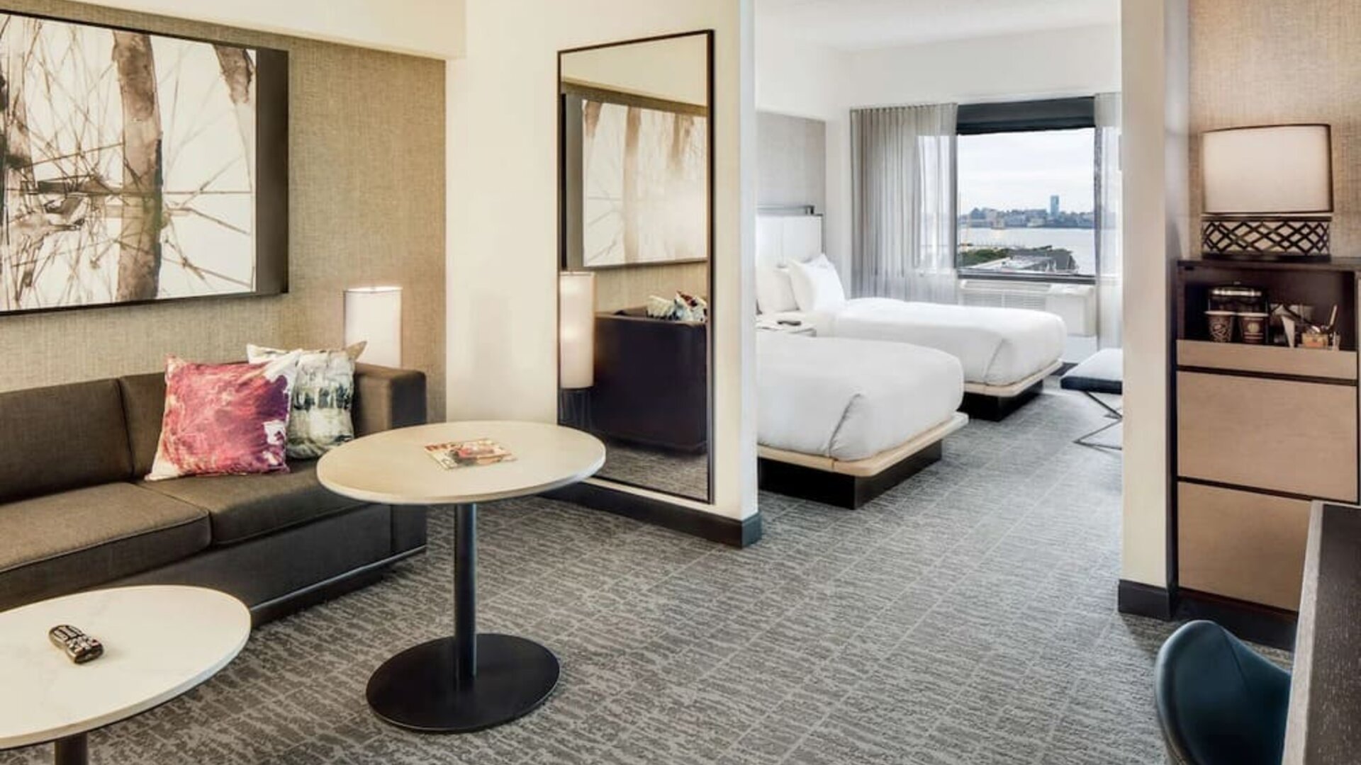 Comfortable day room at DoubleTree By Hilton Jersey City with couch, desk, chair and natural light