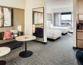 Comfortable day room at DoubleTree By Hilton Jersey City with couch, desk, chair and natural light