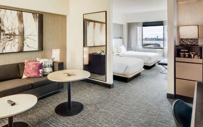 Comfortable day room at DoubleTree By Hilton Jersey City with couch, desk, chair and natural light