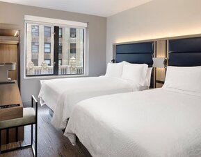 Day use room with a desk, chair, natural light and a beautiful view at Holiday Inn Express New York City - Chelsea.