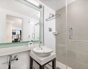Modern bathroom with plush towels at New Yorker by Lotte Hotels