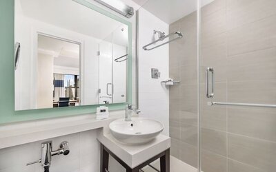 Modern bathroom with plush towels at New Yorker by Lotte Hotels