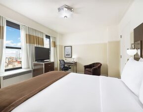 Day use room with work desk and natural light at New Yorker by Lotte Hotels.