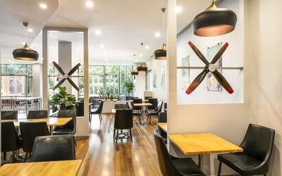 Dining area with natural light perfect for coworking at Crowne Plaza Sydney Airport.
