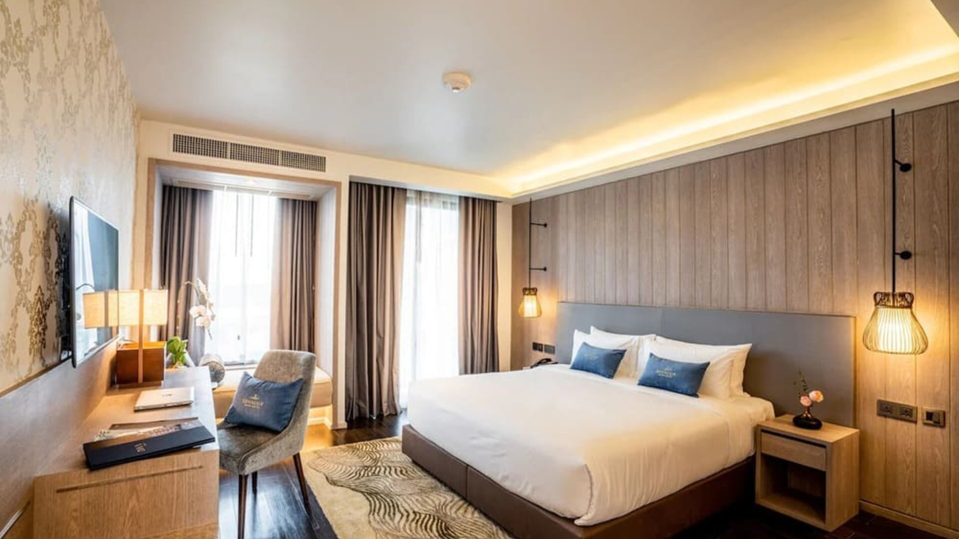 Day room with work desk and chair and natural light at Divalux Resort & Spa Bangkok Suvarnabhumi Airport.