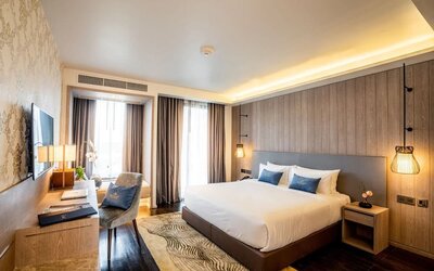 Day room with work desk and chair and natural light at Divalux Resort & Spa Bangkok Suvarnabhumi Airport.