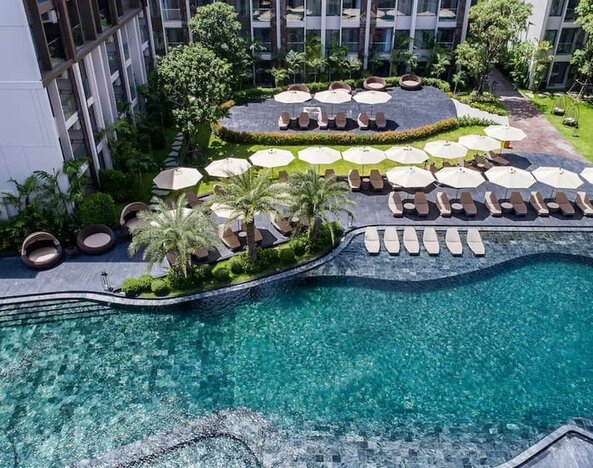Large outdoor pool at Divalux Resort & Spa Bangkok Suvarnabhumi Airport.