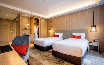 Day room with work desk and chair and natural light at Divalux Resort & Spa Bangkok Suvarnabhumi Airport.