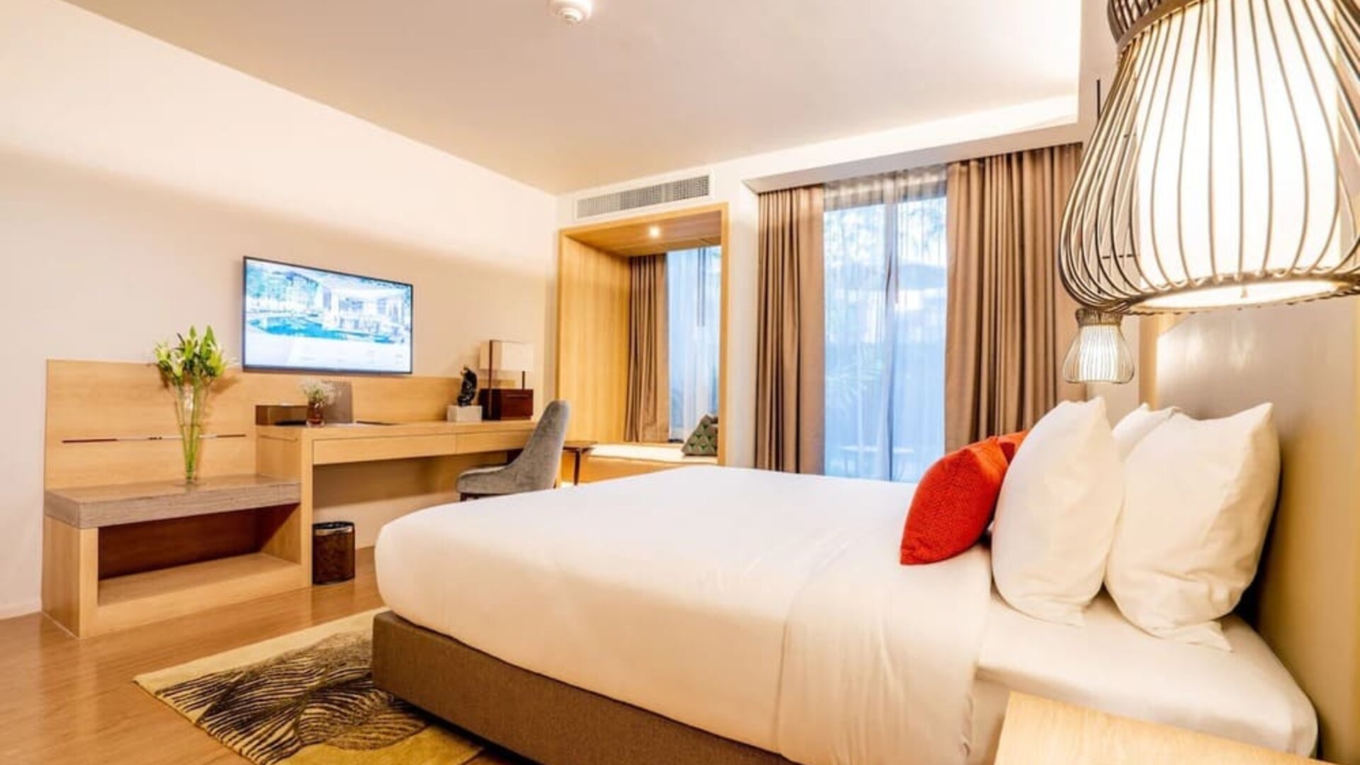 Day room with work desk and chair and natural light at Divalux Resort & Spa Bangkok Suvarnabhumi Airport.