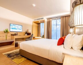 Day room with work desk and chair and natural light at Divalux Resort & Spa Bangkok Suvarnabhumi Airport.