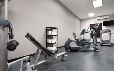 Fully equipped gym at Country Inn & Suites By Radisson, Katy - Houston West to meet all your fitness needs.