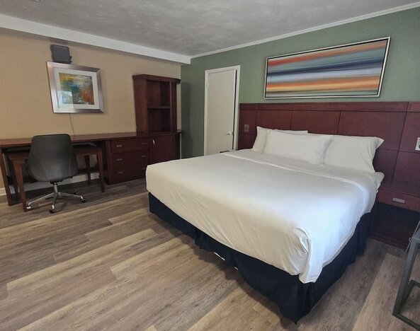 Spacious day room with desk and chair at Nashoba Valley Inn & Suit.