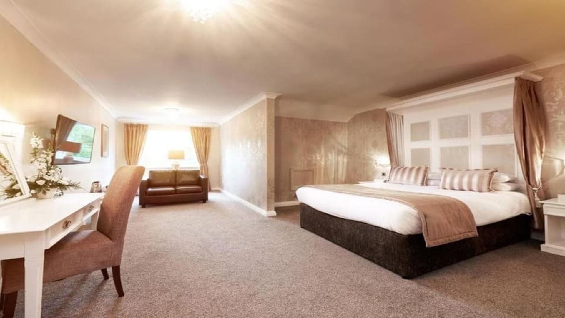 Day room with work area and a comfortable couch at The Old Golf House Hotel.