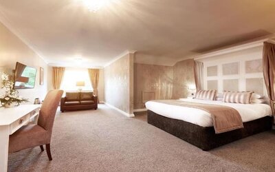 Day room with work area and a comfortable couch at The Old Golf House Hotel.