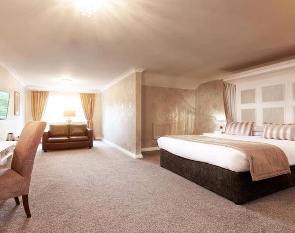 Day room with work area and a comfortable couch at The Old Golf House Hotel.