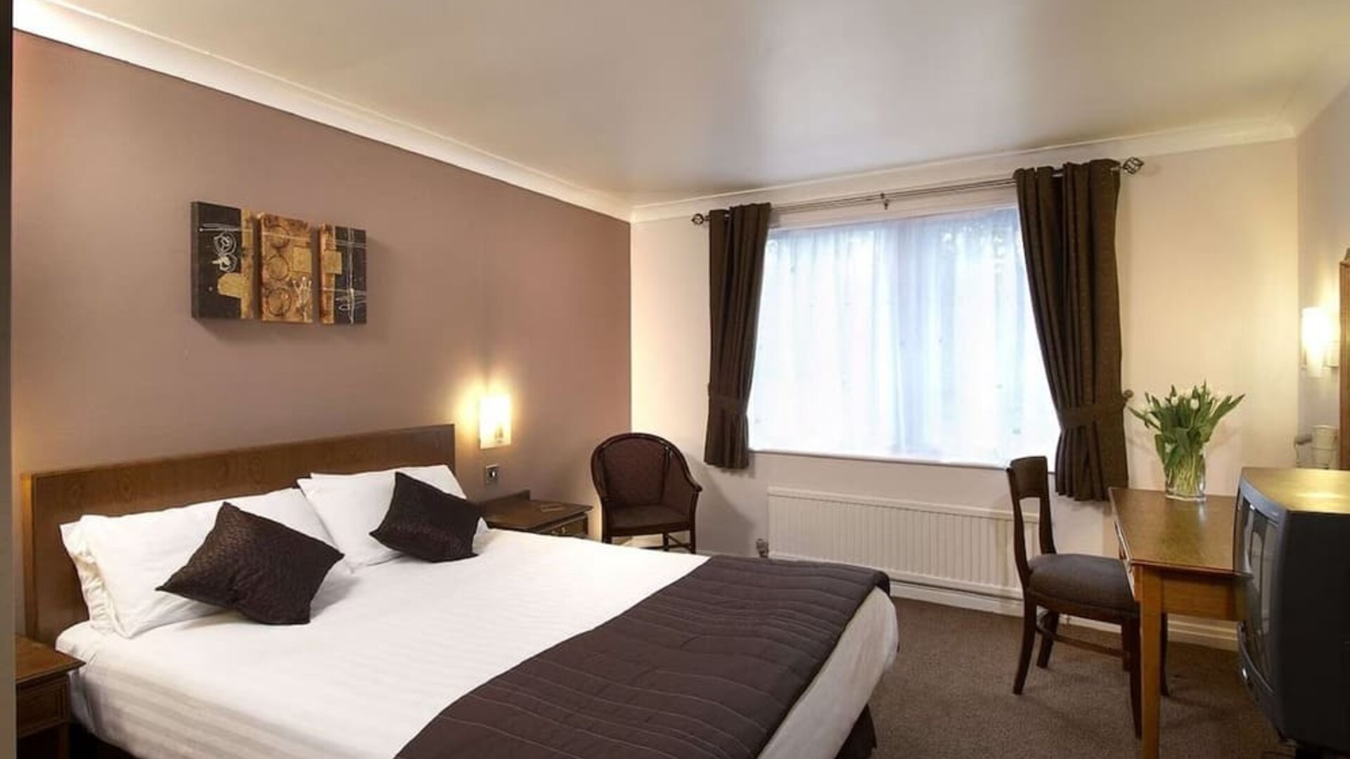 Day room with workspace and natural light at The Old Golf House Hotel.