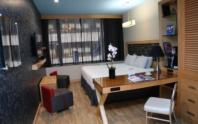 Room at the TRYP By Wyndham Times Square South containing desk, bed, and a television.