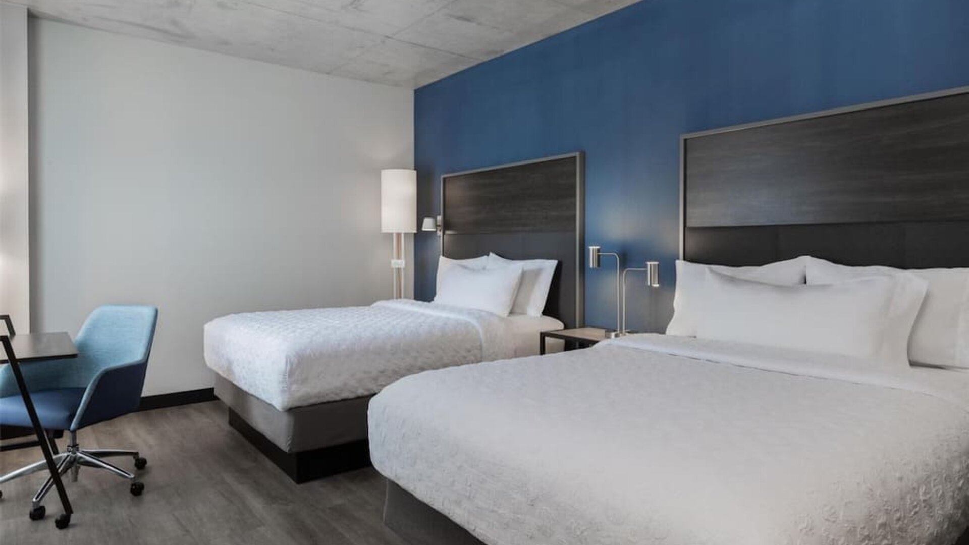 Two beds with work chair and desk at Tru By Hilton Montreal Centre-Ville.