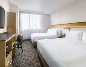 Guest room in the DoubleTree Times Square South, with a workspace desk and chair.