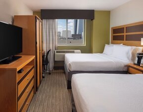 Day room at the Holiday Inn Express Times Square’s with workspace and a televison.