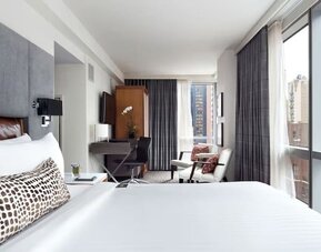 Day use room with workspace, large windows and natural light at Hotel 48LEX New York.
