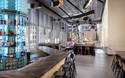 Stylish bar at M Social Hotel Times Square   ideal for unwinding after a busy day.