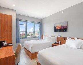 Day use room with work desk and natural light at Liberty View Brooklyn Hotel.