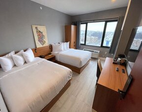 Day use room with work desk and natural light at Liberty View Brooklyn Hotel.