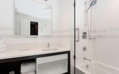 Modern bathroom with plush towels at Courtyard By Marriott Long Island City/New York Manhattan View.