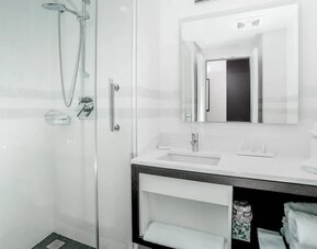 Modern bathroom with plush towels at Courtyard By Marriott Long Island City/New York Manhattan View.