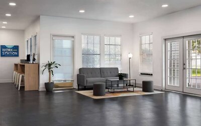 Lobby area with couch and a work station at Baymont by Wyndham Maingate.