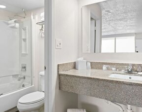 Modern bathroom with towels at Baymont by Wyndham Maingate.