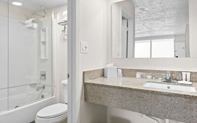 Modern bathroom with towels at Baymont by Wyndham Maingate.