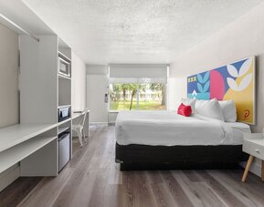 Day room with workspace and natural light at Baymont by Wyndham Maingate.