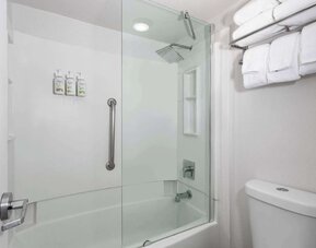Modern bathroom with towels at Baymont by Wyndham Maingate.