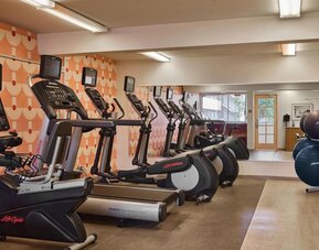 Fitness center with cardio machines including treadmills and ellipticals at The Ambassador Hotel Of Waikiki.