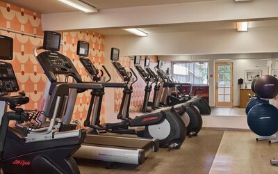 Fitness center with cardio machines including treadmills and ellipticals at The Ambassador Hotel Of Waikiki.