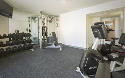 Fitness center with free weights, cable machine, and exercise bike at Park Shore Waikiki.