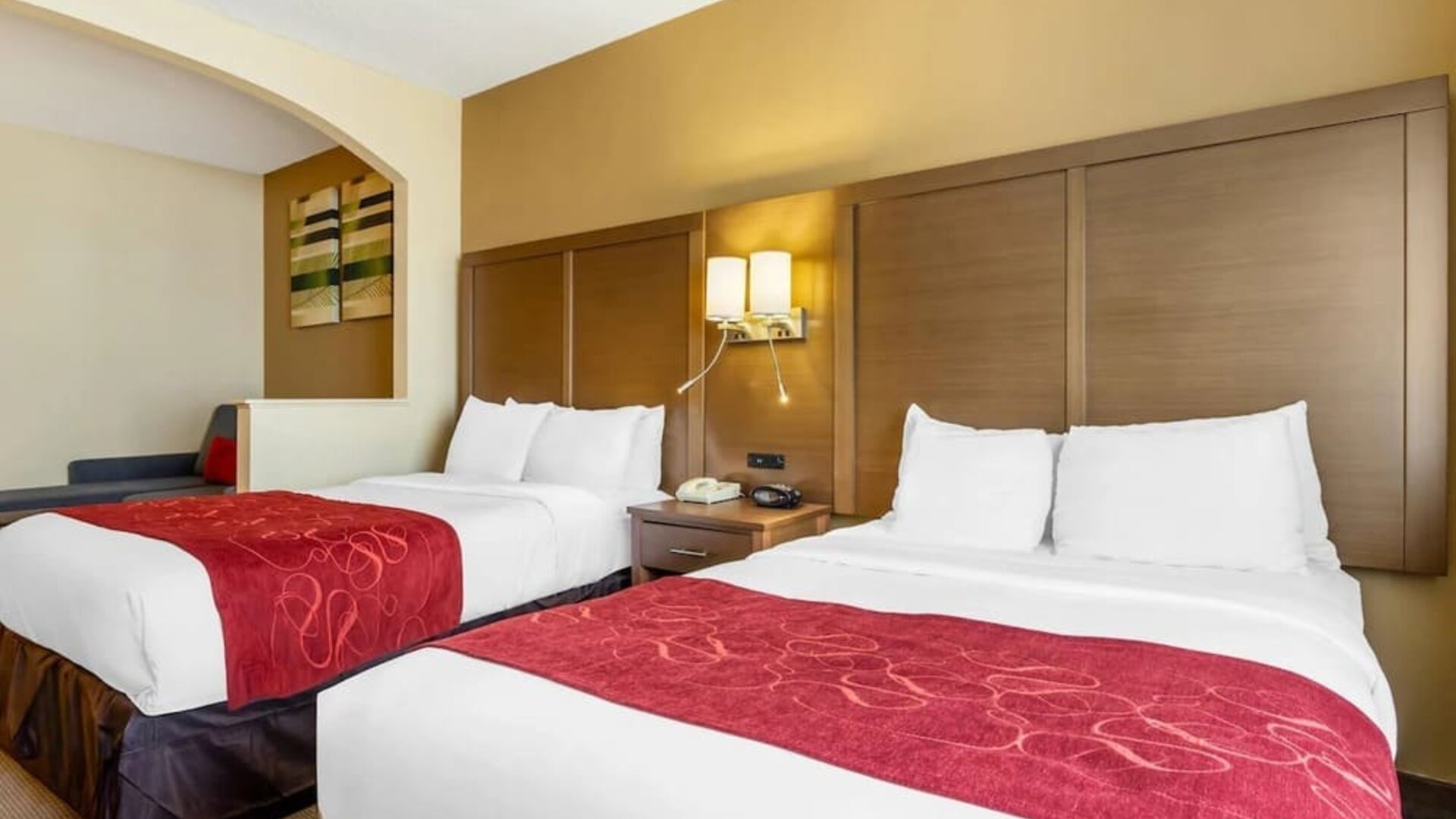 Day room with two beds, shared nightstand, and wall-mounted reading lights at Comfort Suites Bush Intercontinental Airport.