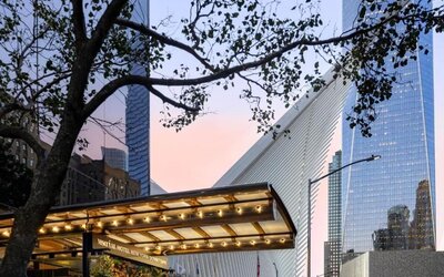Hotel exterior entrance with covered canopy and surrounding city architecture at M Social New York Downtown.