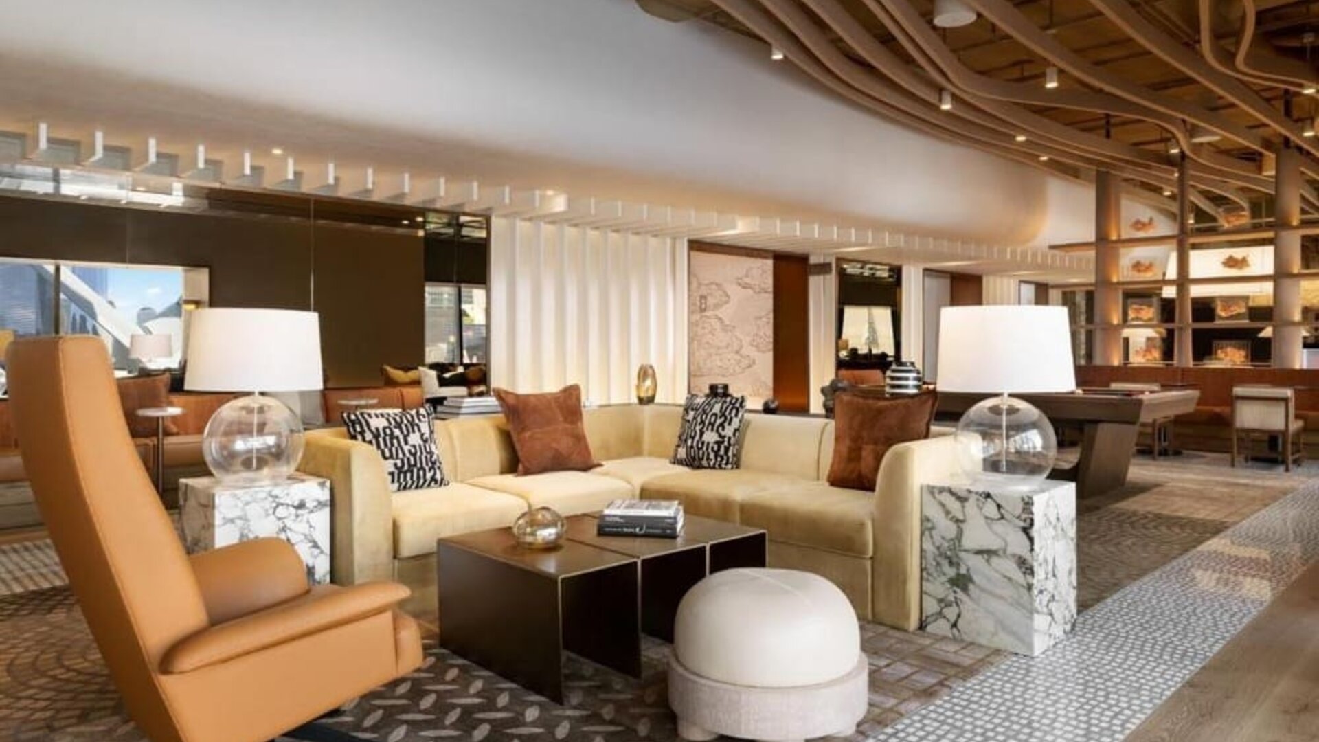 Stylish lobby lounge with sofas, marble tables, decorative lighting, and contemporary design at M Social New York Downtown.