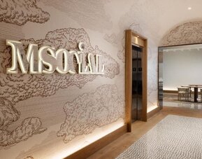 Reception area with illuminated M Social signage, wall art, and elevator access at M Social New York Downtown.