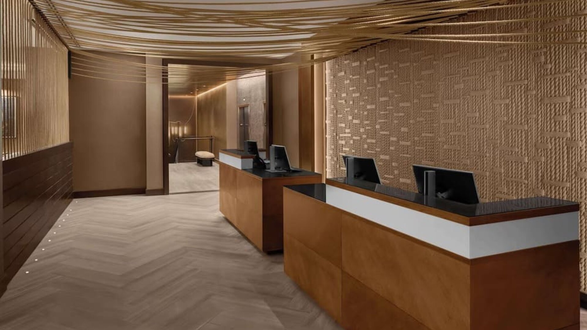 Reception desk area with modern design and warm lighting at Hilton Brooklyn New York.