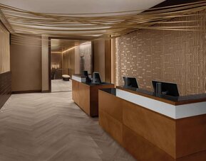 Reception desk area with modern design and warm lighting at Hilton Brooklyn New York.
