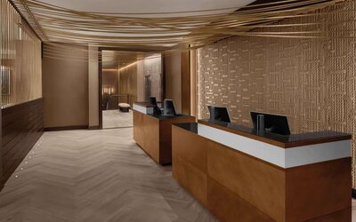 Reception desk area with modern design and warm lighting at Hilton Brooklyn New York.