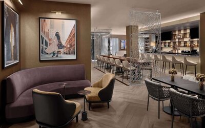 Lounge and bar area with seating, tables, and dining space at Hilton Brooklyn New York.