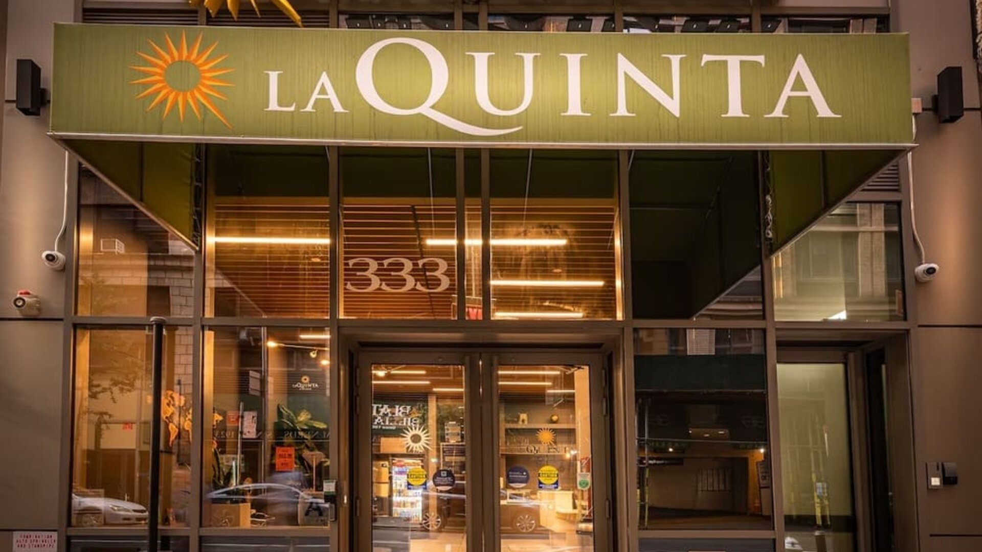 Hotel entrance with La Quinta signage and glass doors at La Quinta Times Square South.
