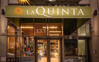 Hotel entrance with La Quinta signage and glass doors at La Quinta Times Square South.