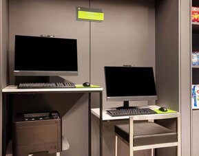 Business center with computers, workspace desks, and printer facilities at La Quinta Times Square South.