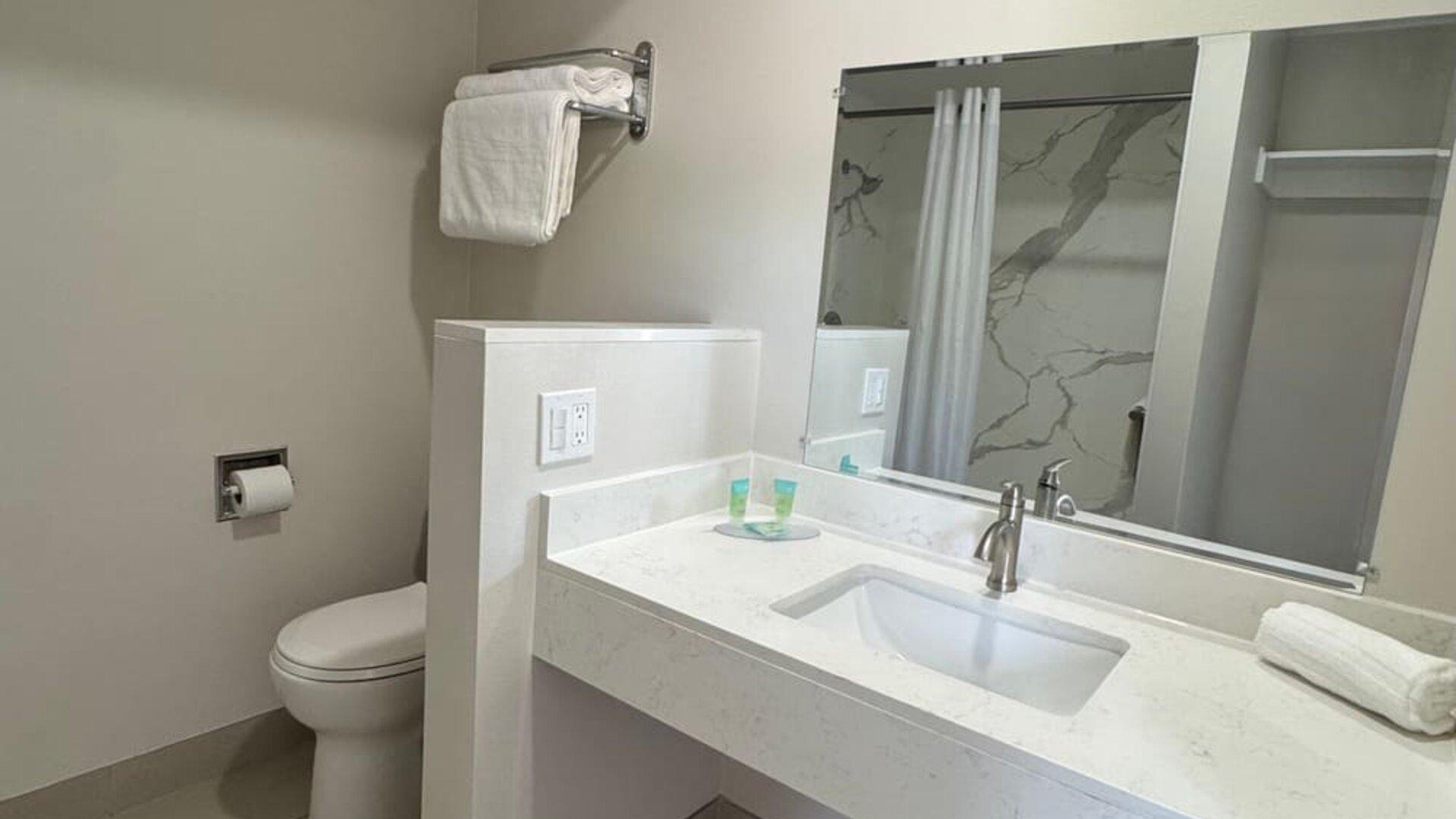 Guest bathroom with shower and toilet at Economy Inn.